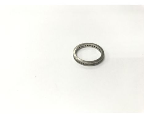 A platinum and dated diamond eternity ring. Weight approx 3.36g, M/N.