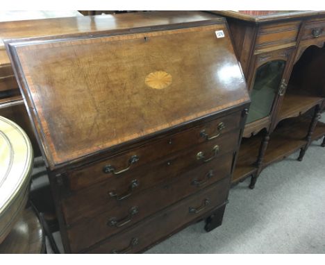 A Edwardian mahogany inlaid bureau the fall front above four drawers on bracket feet