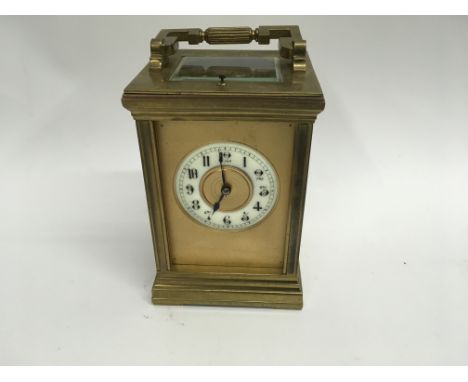 A French brass carriage clock with repeat button visible escapement the dial with Roman Arabic numerals