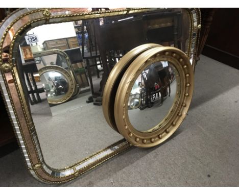 A gilt framed circular mirror and a modern mirror