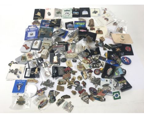 Two vintage golly badges together with a collection of enamel badges from around the world.