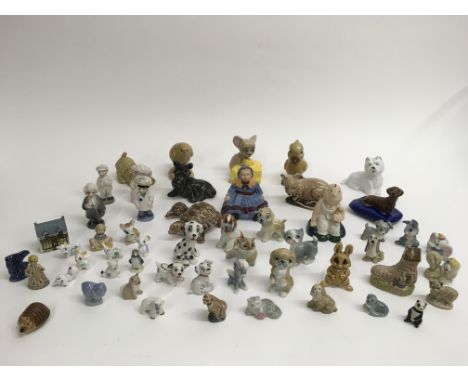 A collection of various Wade figures and Whimsies including Pearly King and Queen and Disney characters