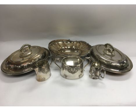 A pair of silver plated entree dishes, basket and a three piece tea service.