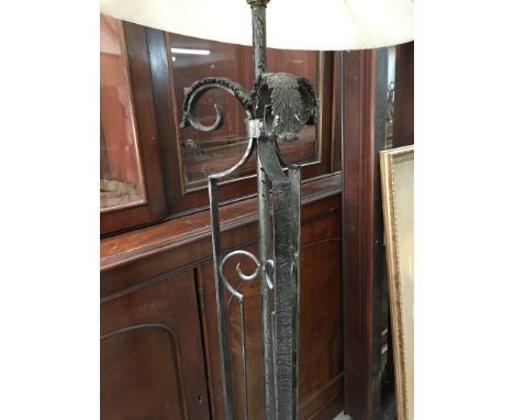 A cast metal standard lamp in the Art Deco style with cream shade