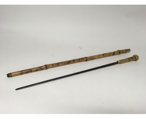 A Victorian bamboo swordstick with an engraved blade