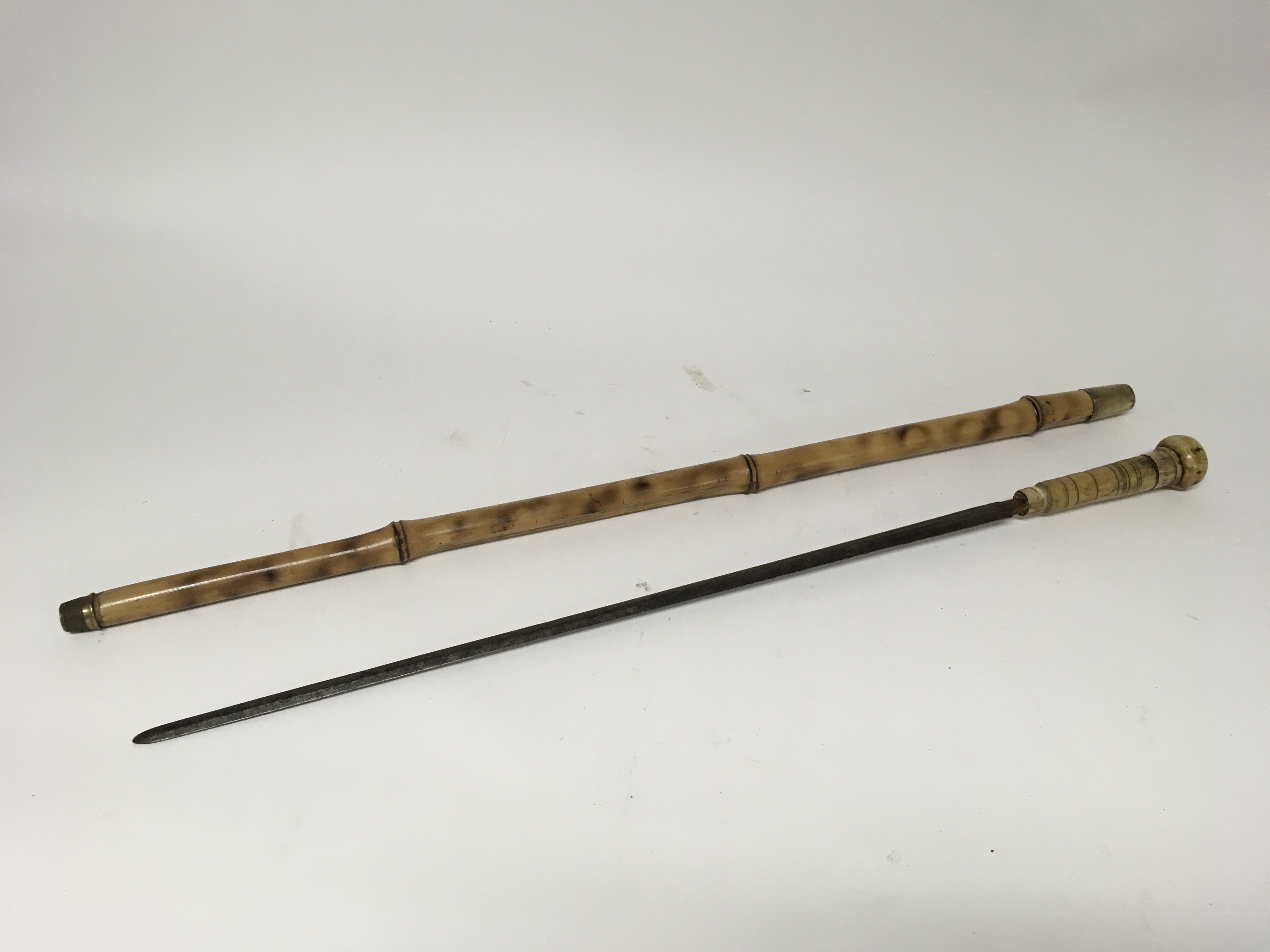 A Victorian bamboo swordstick with an engraved blade