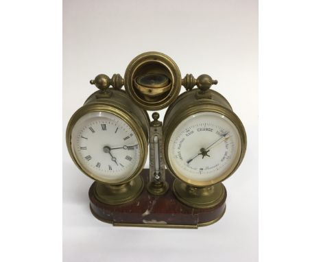 A brass desktop clock with barometer, thermometer and compass top