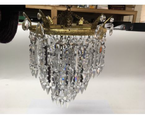 A three tier chandelier with cut glass drops.
