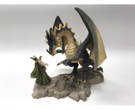 A limited edition (513 of 999) 'Land of Legend' ceramic figure of a wizard confronting a dragon.