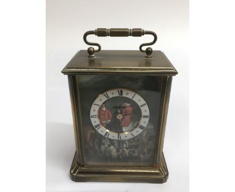 An Acctum, battery operated brass carriage clock decorated with hunting scene