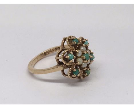 An Edwardian 9ct gold ring having floral design set with pearls and turquoise stones.Approx size K