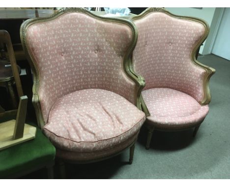 A pair of carved French beechwood armchairs, one cushion missing.