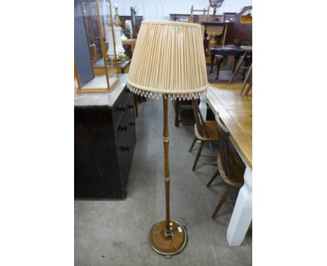 A beech and brass standard lamp 