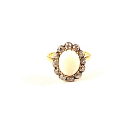 An 18ct Gold Opal and Diamond cluster ring, central Opal set with twelve old cut Diamonds surround, size J (Opal is very rubb