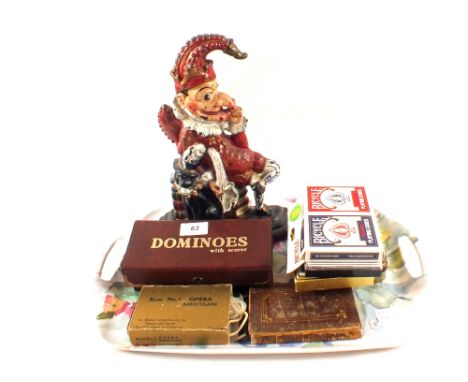 An Iron Mr Punch doorstop plus dominoes, playing cards etc