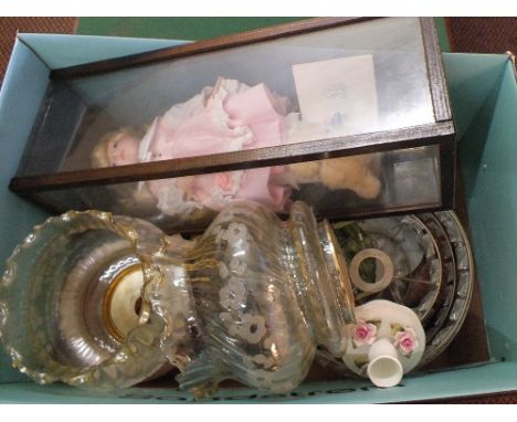 A box of various china, lamp shades plus a porcelain doll in case