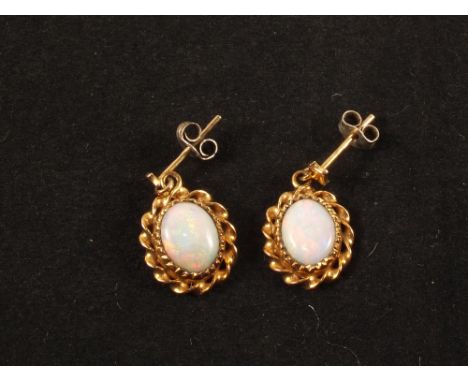 A pair of 9ct Gold mounted Opal earrings (non matching butterfly backs)