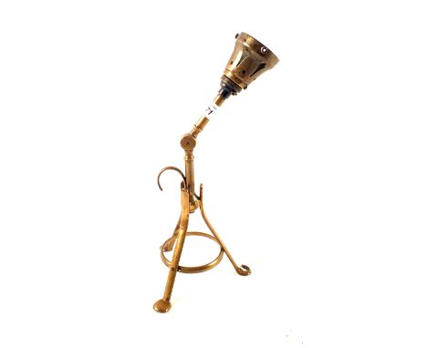 An Arts and Crafts adjustable Brass table lamp in the manner of Benson, raised on tripod supports, 15" high overall