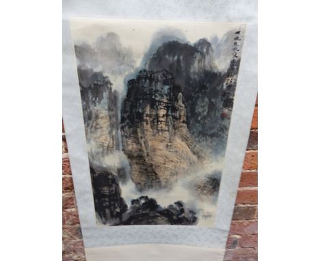 A CHINESE SCROLL PAINTING OF THREE SHIPS SAILING THROUGH A MASSIVE GORGE.   69 x 44cms.