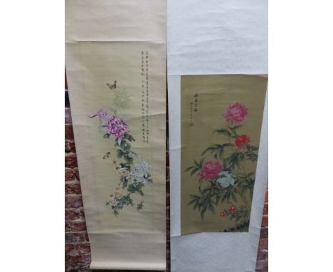 A CHINESE SCROLL PAINTING OF BUTTERFLIES ABOUT CHRYSANTHEMUMS.   96 x 30cms. TOGETHER WITH ANOTHER OF PEONIES ON SILK.   84 x