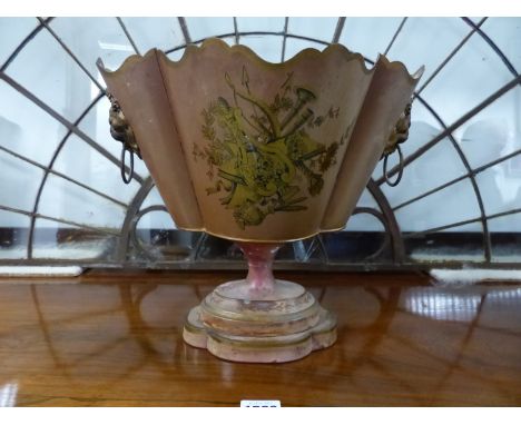 A TOLE MONTEITH SHAPED PLANTER WITH LION MASK AND RING HANDLES TO A PALE BROWN BODY GILT WITH A MUSICAL TROPHY TO ONE SIDE AB