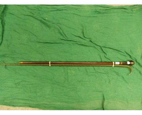 A SPIRAL TWIST GREEN GLASS WALKING STICK TOGETHER WITH A MAHOGANY WALKING CANE, THE POMMEL HANDLE UNSCREWING ONTO A SNUFF BOX