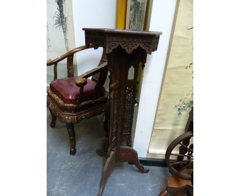 AN ISLAMIC PIERCED AND CARVED WOOD HEXAGONAL TRIPOD TORCHERE.   W 39 x D 34 x H 102cms.