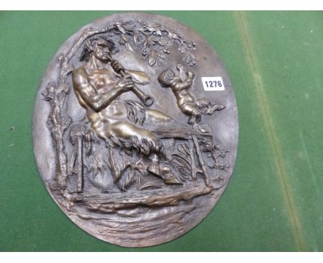 AFTER CLODION, A 19th C. BRONZE OVAL PLAQUE DEPICTING IN RELIEF A SATYR SEATED ON A BENCH WHILE HIS CHILD REACHES UP FROM IT 