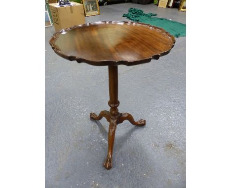 A 19th C. MAHOGANY TILT TOP TABLE, THE CIRCULAR TOP WITH PIE CRUST EDGE, THE GUN BARREL COLUMN ON TRIPOD WITH BALL AND CLAW F