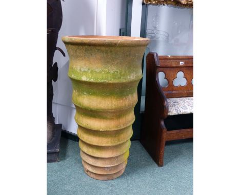 A LARGE TERRACOTTA CYLINDRICAL FORM GARDEN PLANTER WITH RIBBED BANDED DECORATION. H. 92 x Dia. 52cms.