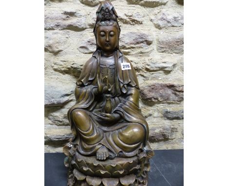 A CHINESE BRONZE FIGURE OF GUANYIN SEATED ON LOTUS WASHED BY WAVES, SHE HOLDS A PEARL IN HER RIGHT HAND AND A VASE OF DEW IN 