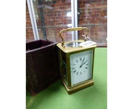 A LEATHER CASED CARRIAGE CLOCK STRIKING ON A COILED ROD.   H 15cms.