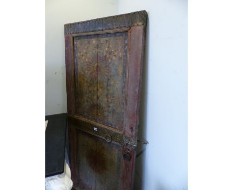 AN EASTERN DOOR, THE FRONT PAINTED WITH TWO PANELS OF GEOMETRIC TILE DESIGNS SEPARATED BY BANDS OF BRASS, THE BACK PAINTED WI