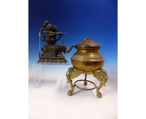 AN INDIAN BRONZE TRIPLE LIGHT OIL LAMP WITH NAGA HANDLE AND SUPPORTED ON THE BACK OF AN ELEPHANT.   H 18cms. TOGETHER WITH AN