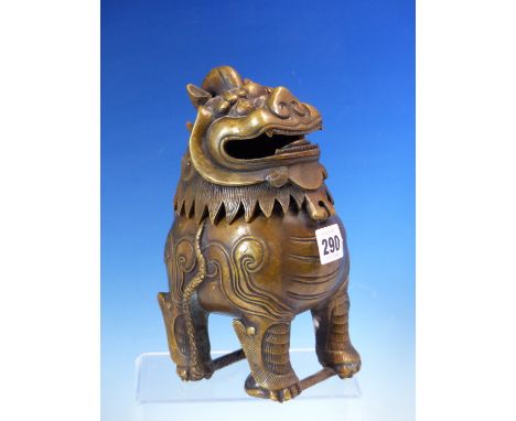 A CHINESE BRONZE INCENSE BURNER IN THE FORM OF A BUDDHIST LION, FOUR CHARACTER MARK ON ITS BELLY.   H 22cms.