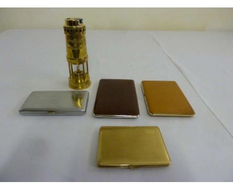 Four cigarette cases and a lighter in the form of a Davy lamp