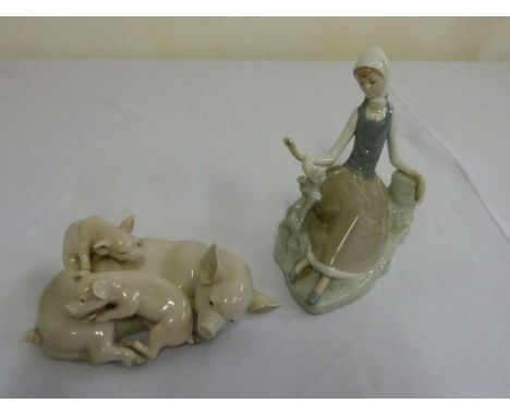 Lladro two porcelain figurines of seated lady and a group of pigs