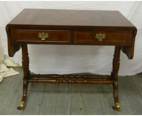 Mahogany sofa table, two drawers, drop flaps on turned outswept supports with original brass castors