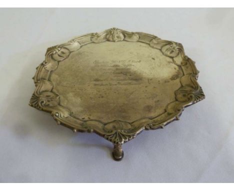 Silver salver with scroll and shell borders on three pad feet, engraved and dated to the centre, Sheffield 1911 by William Hu