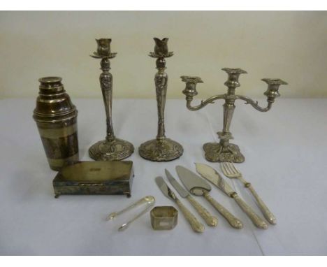 A quantity of silver plate to include a pair of table candlesticks, a candelabra, a cigarette box, a cocktail shaker, a silve