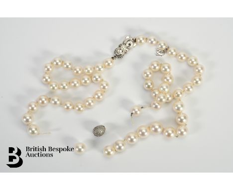 A Mikimoto pearl necklace, set with 7mm pearls terminating on a 18ct white gold clasp, with an M charm, approx 38 cms togethe