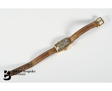 Vintage 9ct gold Omega tank wrist watch. The watch case measures 26 x 18mm, having a silvered face with Arabic dial, on leath