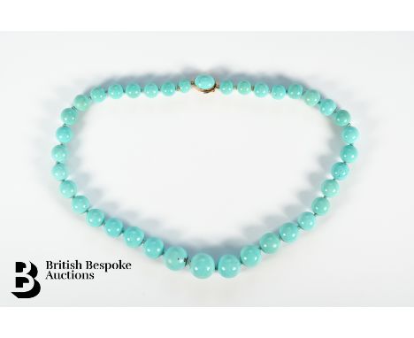 A vintage single strand graduated turquoise bead necklace, measuring from 8mm to 15mm,&nbsp; terminating in a 18k gold caboch