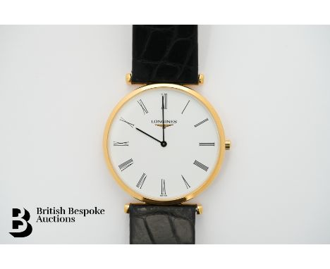 A gentleman's 2021 18ct yellow gold Longines wrist watch. The watch case measuring 34mm, having a white face with Arabic dial