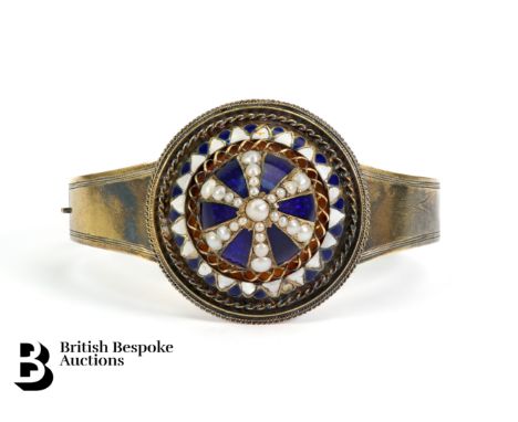 Victorian 14ct yellow gold and enamel bangle, the blue enamel crown heightened with seed pearls and measures 36mm, the bracel