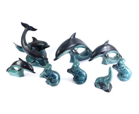 A group of Poole pottery, comprising four dolphins and three seals. (1 tray)