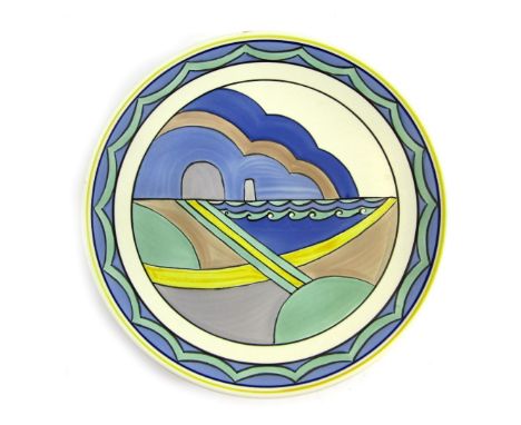 A Poole pottery cabinet plate, with blue, yellow and green painted decoration, stamped to underside, 27cm diameter. 