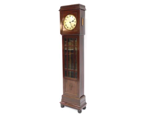 A 20thC mahogany longcase clock, with a turreted top and beaded border, around a silvered Roman numeric clock dial, with mirr