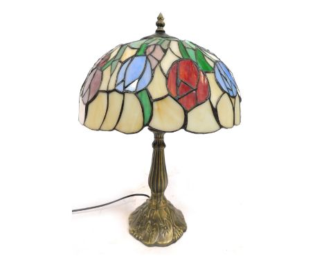 A Tiffany style table lamp, with a cream tulip shade, on a petalated foot, 51cm high.