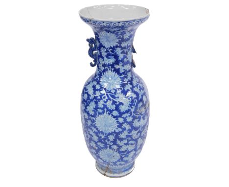 A 19thC Qing Dynasty blue and white porcelain vase, with dragon handles, decorated with flowers and scrolling leaves, against